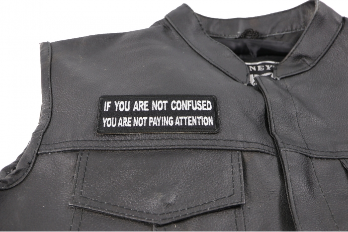 If You are Not Confused You are not Paying Attention Patch - 4x1.5 inch. Embroidered Iron on Patch shown on leather vest