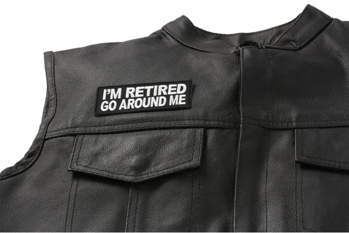 I'm Retired Go Around Me Patch - 4x1.5 inch. Embroidered Iron on Patch shown on leather vest