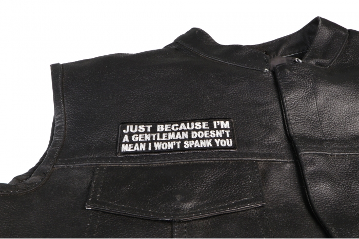 Just Because I'm A Gentleman Doesn't Mean I Won't Spank You Patch - 4x1.5 inch. Embroidered Iron on Patch shown on leather vest