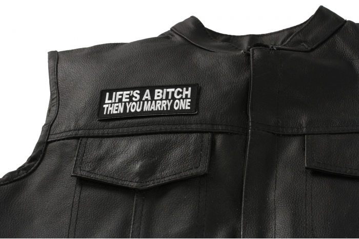 Life's A Bitch Then You Marry One Patch - 4x1.5 inch. Embroidered Iron on Patch shown on leather vest