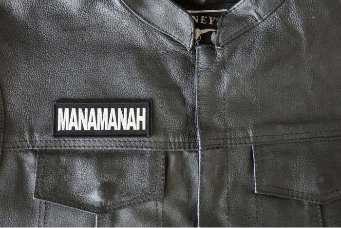 Manamanah Patch - 4x1.5 inch - Embroidered Iron on Patch shown on leather vest
