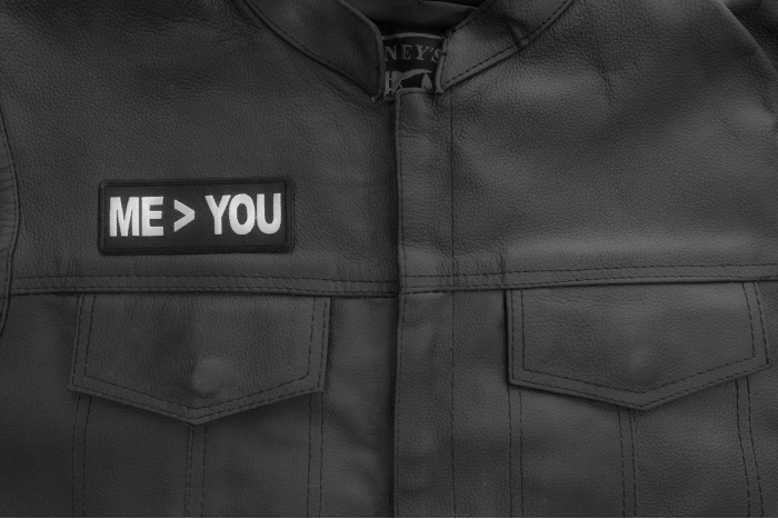 Me greater than you patch shown on leather vest
