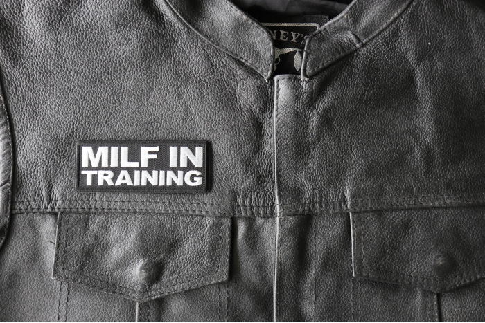 Milf in Training Patch - 4x1.5 inch - Embroidered Iron on Patch shown on leather vest