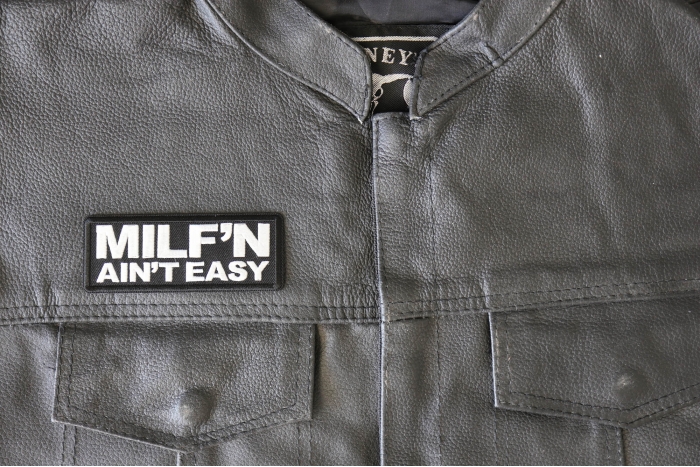 Milf'n ain't easy funny patch - 4x1.5 inch - Embroidered Iron on Patch shown on leather vest
