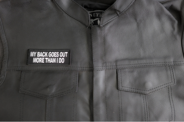 My Back Goes Out More Than I Do Patch shown on leather vest