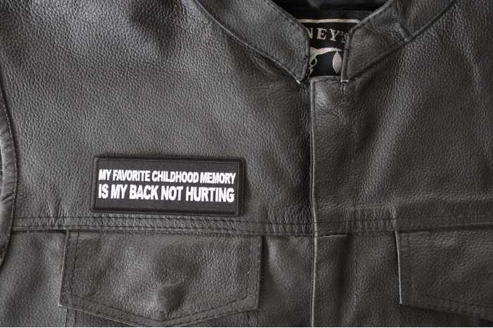 My Favorite Childhood Memory is My Back Not Hurting Patch - 4x1.5 inch - Embroidered Iron on Patch shown on leather vest