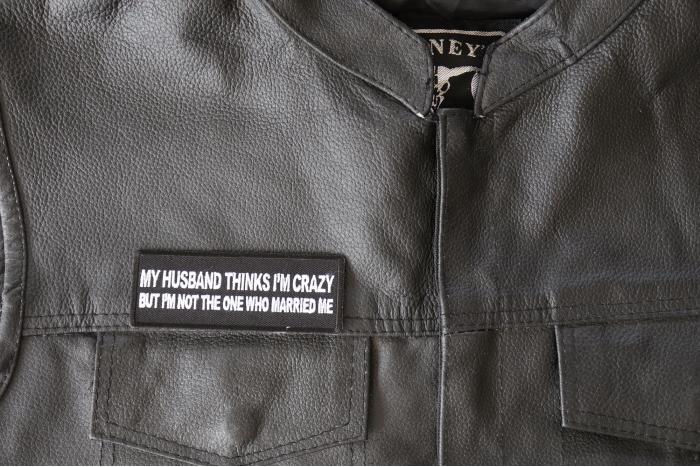 My Husband Thinks I'm Crazy, But I'm not the one who Married Me Patch - 4x1.5 inch - Embroidered Iron on Patch shown on leather vest