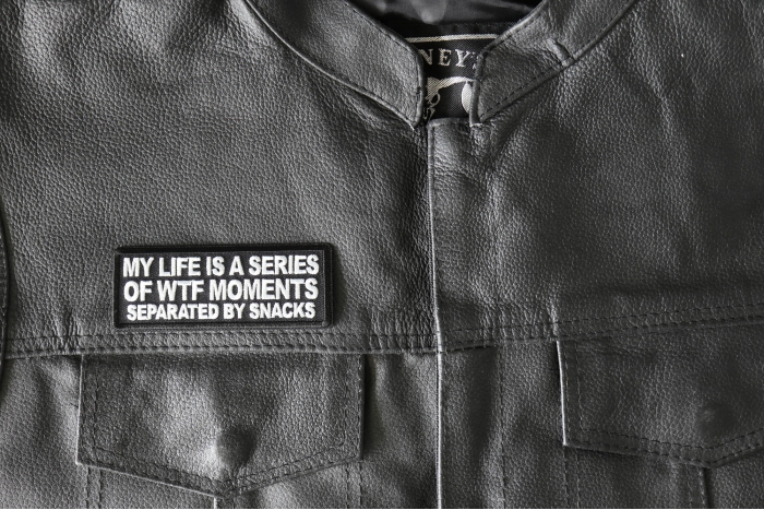 My Life is a Series of WTF Moments separated by Snacks Patch - 4x1.5 inch - Embroidered Iron on Patch shown on leather vest