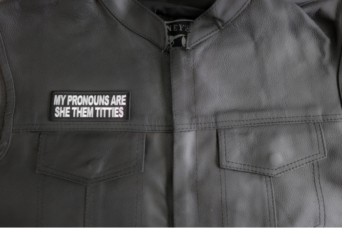 My Pronouns Are She Them Titties Patch shown on leather vest
