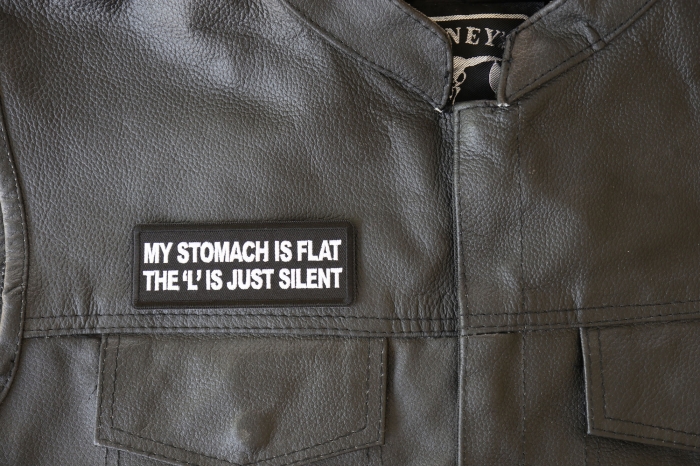 My Stomach is Flat, The L is just Silent Patch - 4x1.5 inch - Embroidered Iron on Patch shown on leather vest
