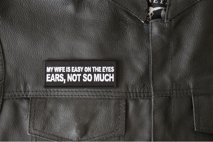 My Wife is Easy on The Eyes, Ears not So Much Patch - 4x1.5 inch - Embroidered Iron on Patch shown on leather vest