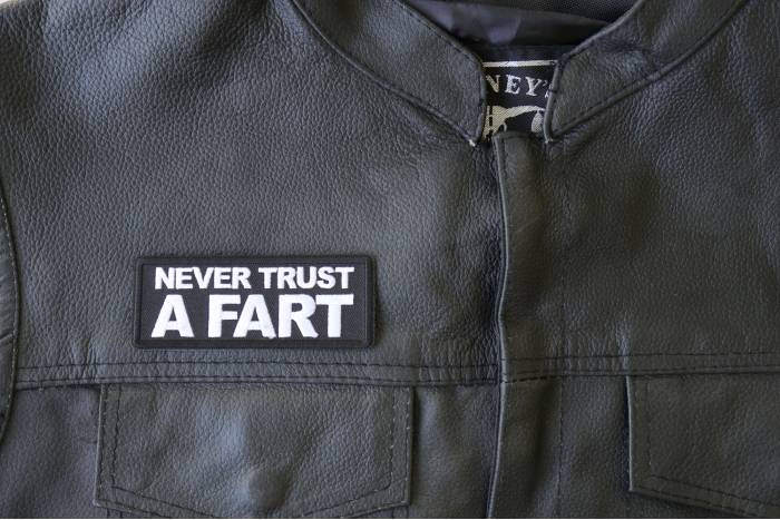 Never Trust a Fart Patch - 4x1.5 inch - Embroidered Iron on Patch shown on leather vest