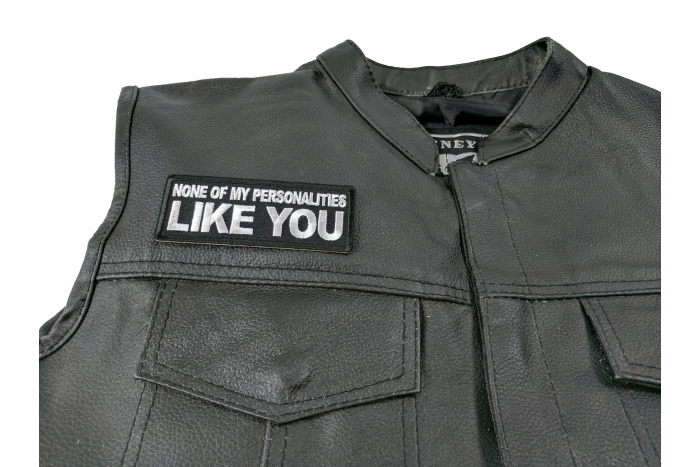 None of My Personalities Like You Patch - 4x1.5 inch. Embroidered Iron on Patch shown on leather vest
