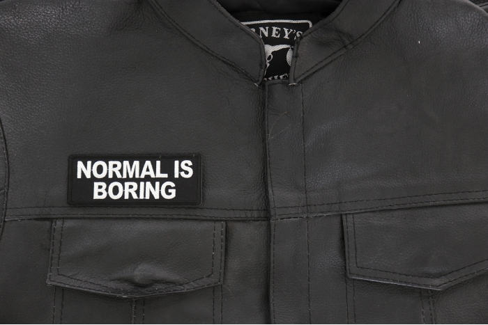 Normal is Boring Patch - 4x1.5 inch - Embroidered Iron on Patch shown on leather vest