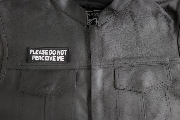 Please Do Not Perceive Me Patch shown on leather vest