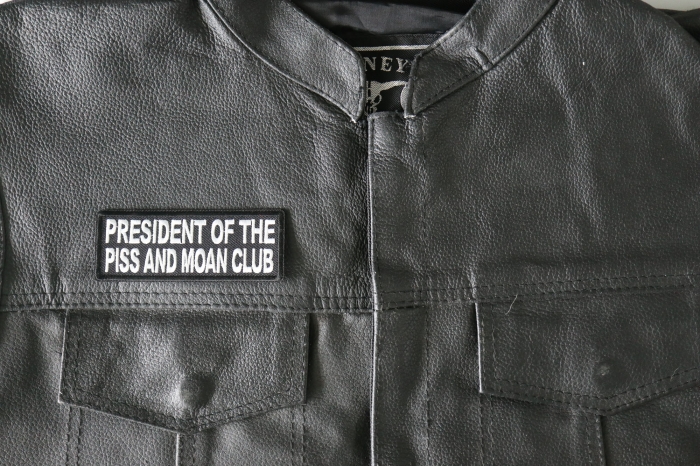President of The Piss and Moan Club Patch, Funny Saying Patches shown on leather vest