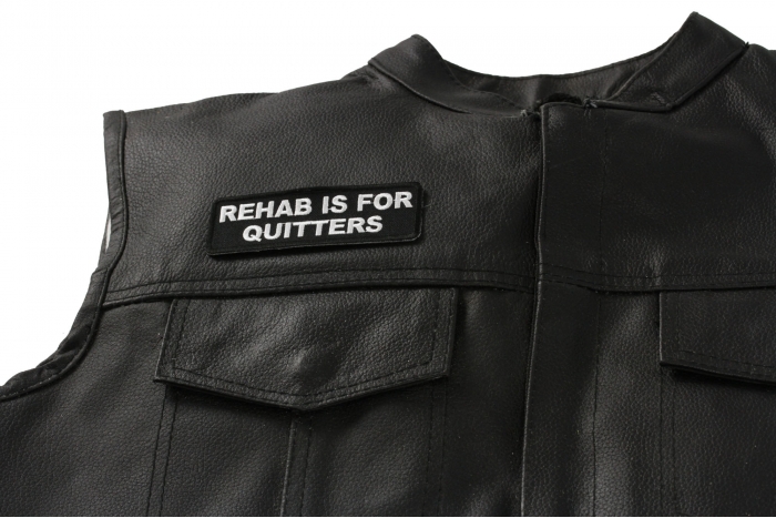 Rehab Is For Quitters Patch - 4x1.25 inch. Embroidered Iron on Patch shown on leather vest