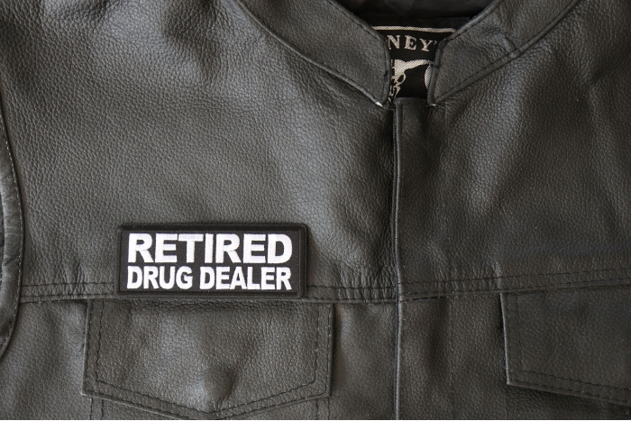 Retired Drug Dealer Patch - 4x1.5 inch - Embroidered Iron on Patch shown on leather vest