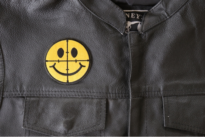 Sniper Scope Smiley Face Patch - 3x3 inch - Embroidered Iron on Patch shown on leather vest