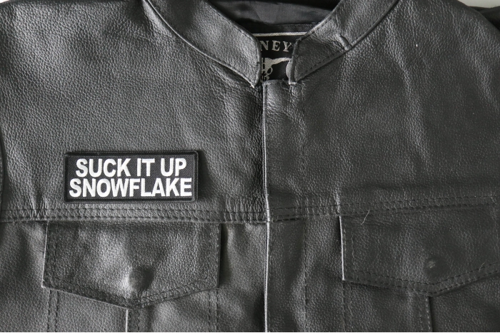 Suck it Up Snowflake Patch - 4x1.5 inch - Embroidered Iron on Patch shown on leather vest