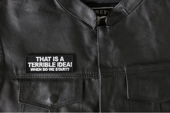 That is a terrible Idea When Do We Start Patch - 4x1.5 inch - Embroidered Iron on Patch shown on leather vest