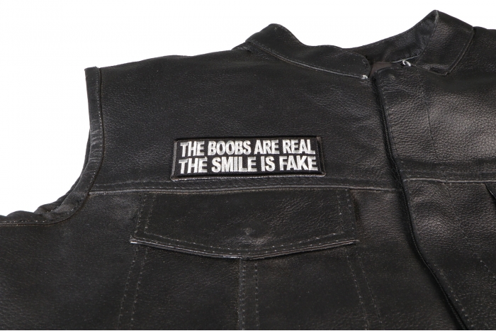 The Boobs are Real The Smile is Fake Patch, Funny Saying Patches shown on leather vest