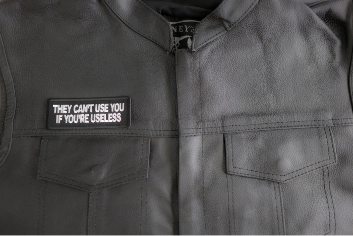 They Cant Use You If You're Useless Patch shown on leather vest