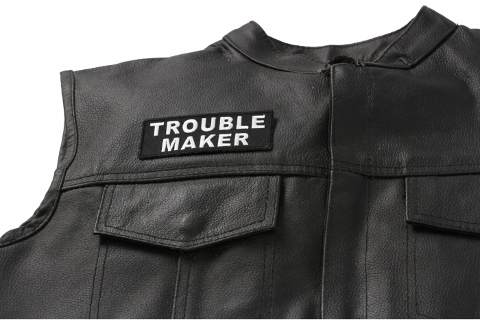 Trouble Maker Patch - 4x1.5 inch. Embroidered Iron on Patch shown on leather vest
