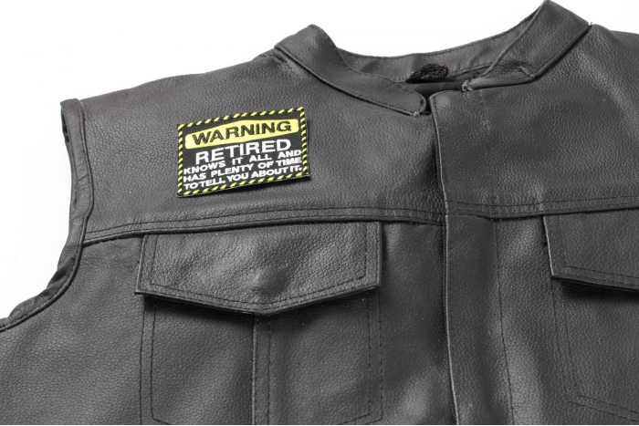 Warning Retired Knows It All Patch - 3x2.5 inch. Embroidered Iron on Patch shown on leather vest
