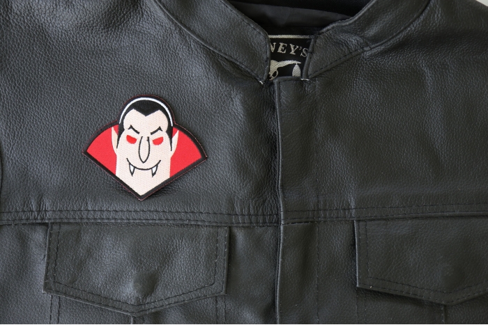 Whacky Dracula Vampire Patch - 3.6x3 inch - Embroidered Iron on Patch shown on leather vest