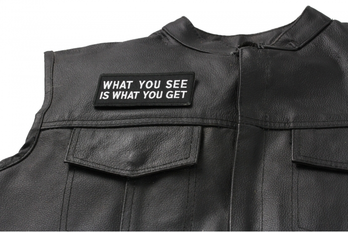 What You See Is What You Get Patch - 4x1.75 inch. Embroidered Iron on Patch shown on leather vest