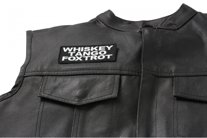 Whiskey Tango Foxtrot Patch - 4x1.5 inch. Embroidered Iron on Patch shown on leather vest