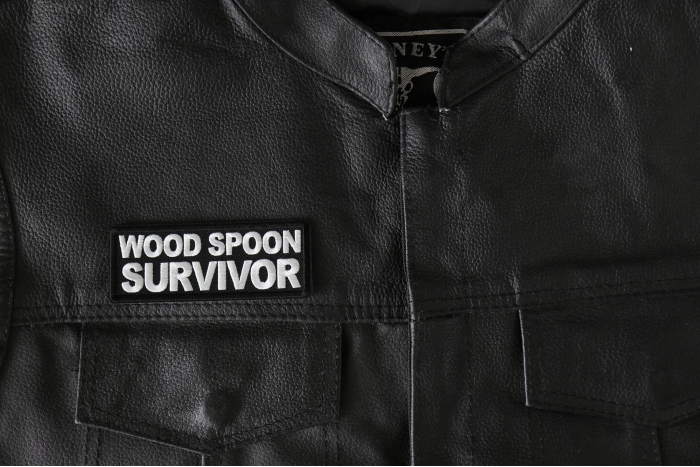 Wood Spoon Survivor Patch - 4x1.5 inch - Embroidered Iron on Patch shown on leather vest
