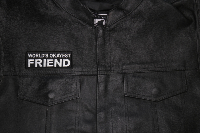 World's Okayest Friend Patch shown on leather vest