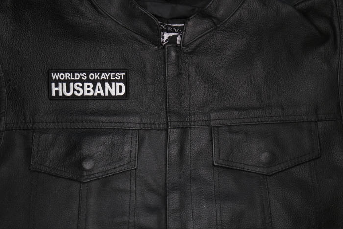 World's Okayest Husband Patch shown on leather vest