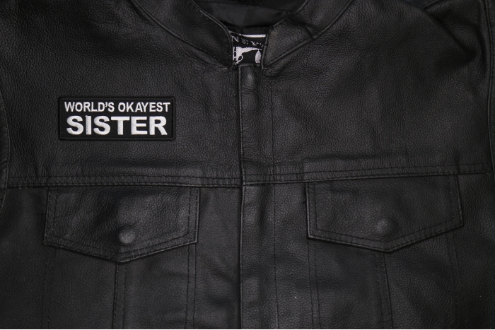World's Okayest Sister Patch shown on leather vest