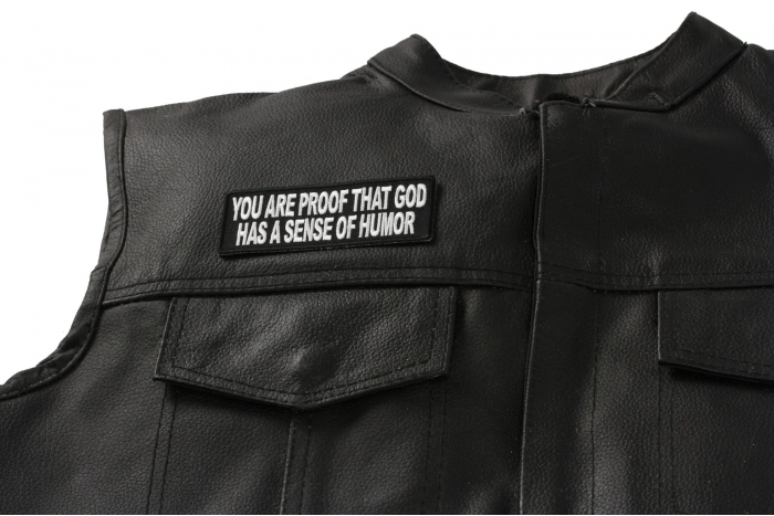 You Are Proof That God Has A Sense Of Humor Patch - 4x1.5 inch. Embroidered Iron on Patch shown on leather vest