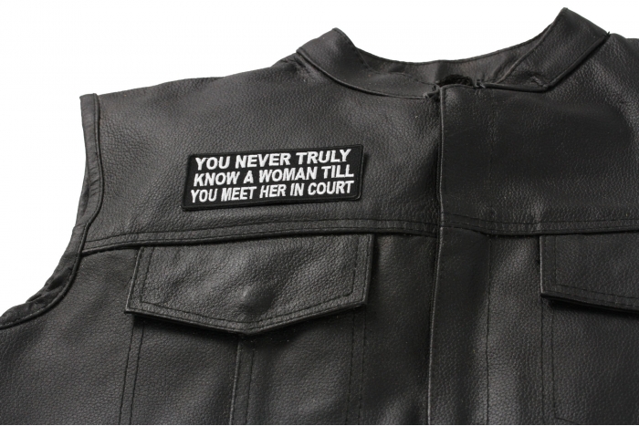 You Never Truly Know A Woman Till You Meet Her in The Court Patch - 4x1.5 inch. Embroidered Iron on Patch shown on leather vest