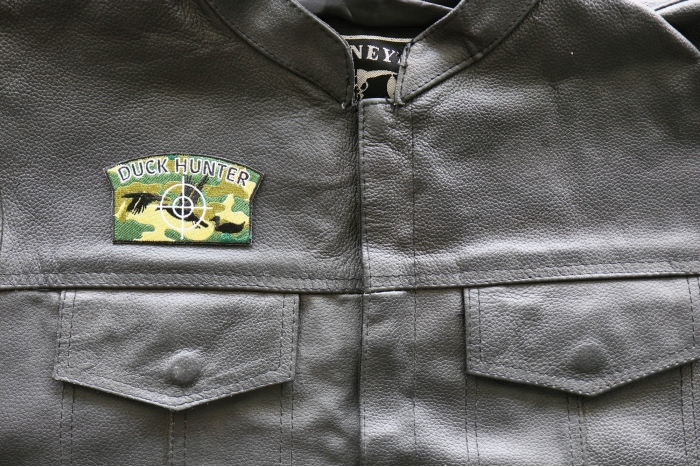 Duck Hunter - 3.5x2 inch - Embroidered Iron on Patch shown on leather vest