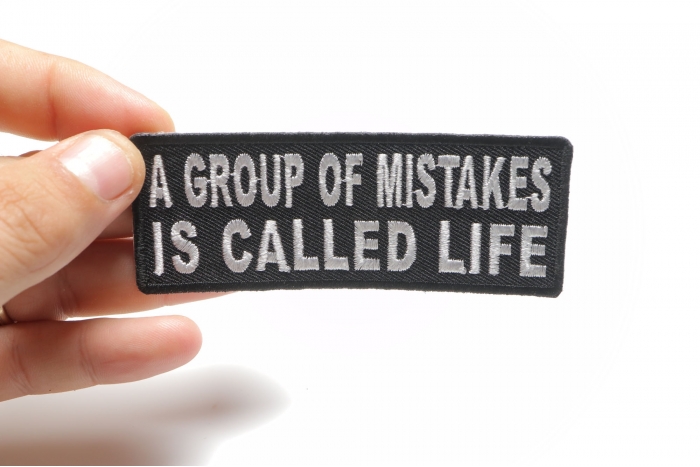 A Group Of Mistakes Is Called Life Funny Iron on Patch shown on hand for size comparison