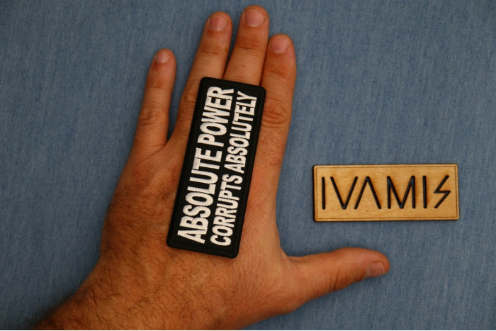 Absolute Power Corrupts Absolutely Patch shown on hand for size comparison