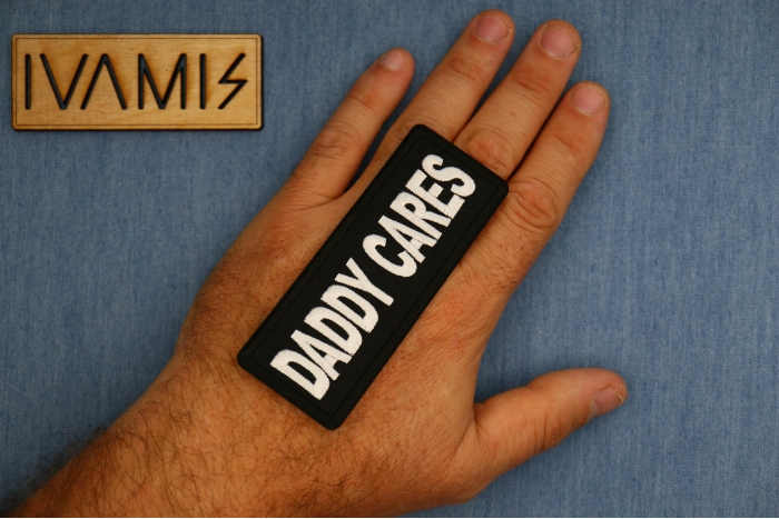 Daddy Cares Patch shown on hand for size comparison