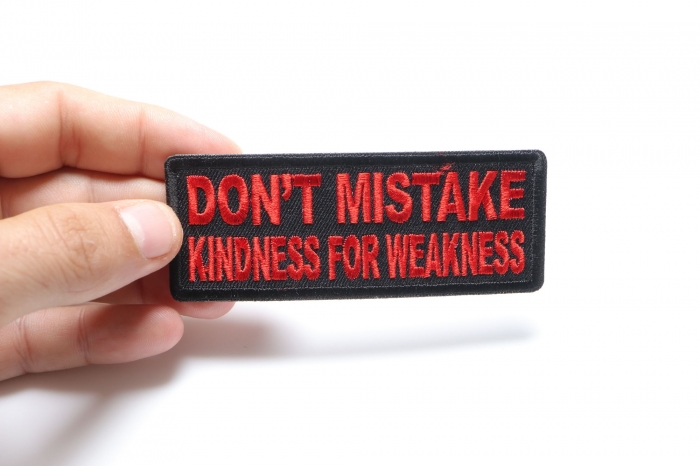 Don't Mistake Kindness for Weakness Patch, Biker Sayings shown on hand for size comparison