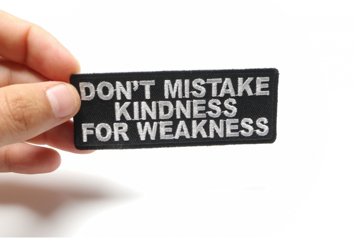 Don't Mistake Kindness For Weakness Patch, Biker Sayings shown on hand for size comparison