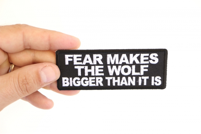 Fear Makes The Wolf Bigger Than it is Iron on Morale Patch shown on hand for size comparison