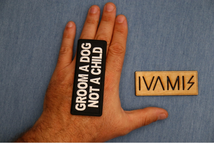 Groom a Dog Not a Child Patch shown on hand for size comparison