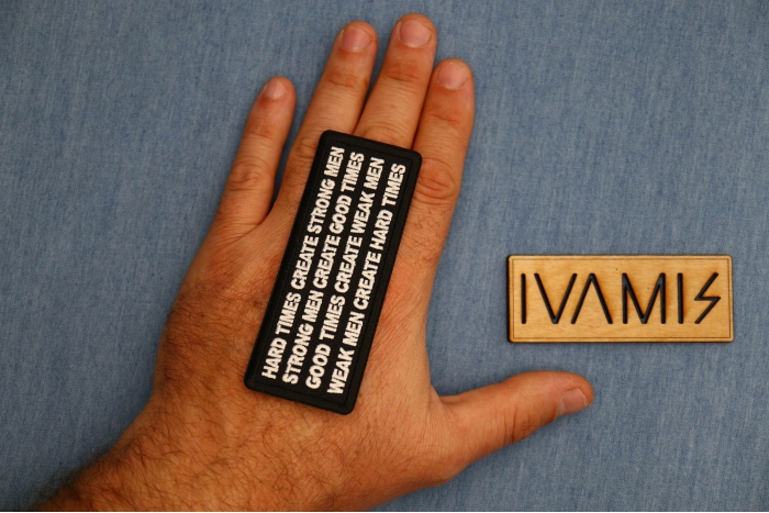 Hard Times Create Strong Men Patch shown on hand for size comparison