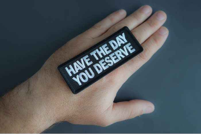 Have The Day You Deserve Patch shown on hand for size comparison