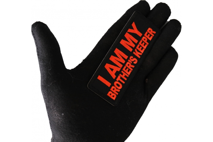 I am My Brother's Keeper Orange Patch shown on hand for size comparison