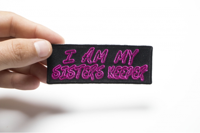 I Am My Sisters Keeper Iron on Morale Patch shown on hand for size comparison